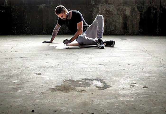 Man writing on floor